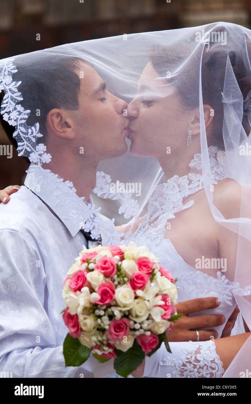 Bride And Groom Kissing Under The Veil Stock Photo Alamy