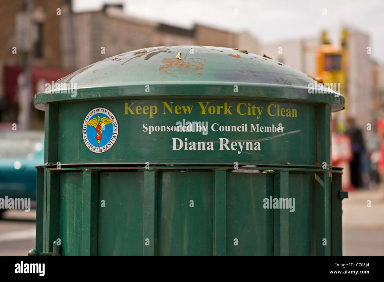 A New York City trash can stands on the corner of a Brooklyn street