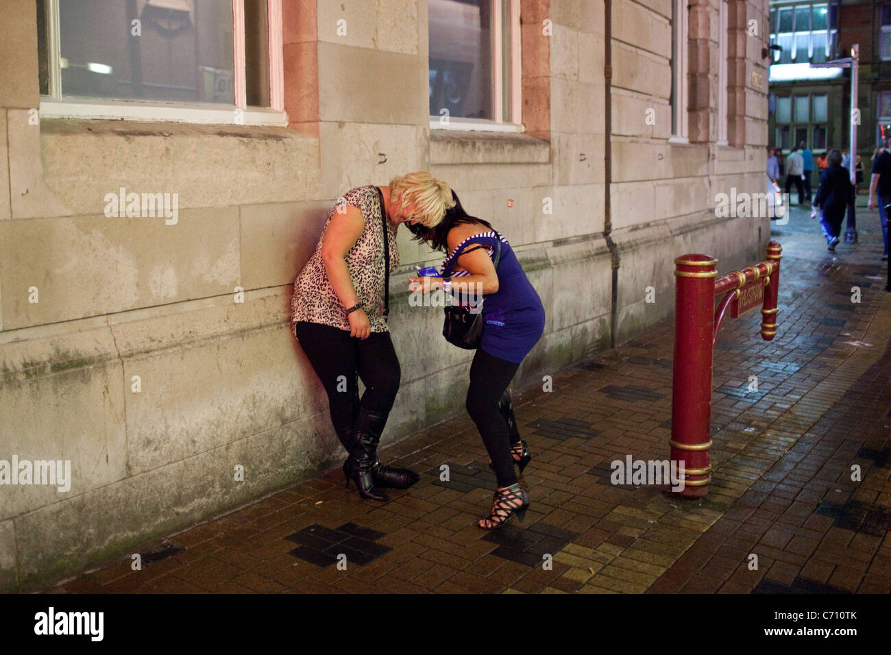 Two women urinate thorough their clothes outside one of the c photo