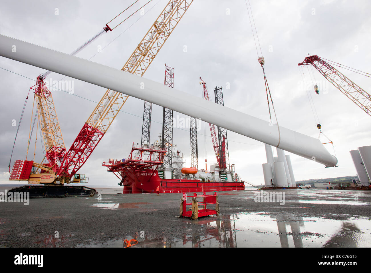 Wind Turbine Blades Being Lifted Onto A Jack Up Barge To Construct The