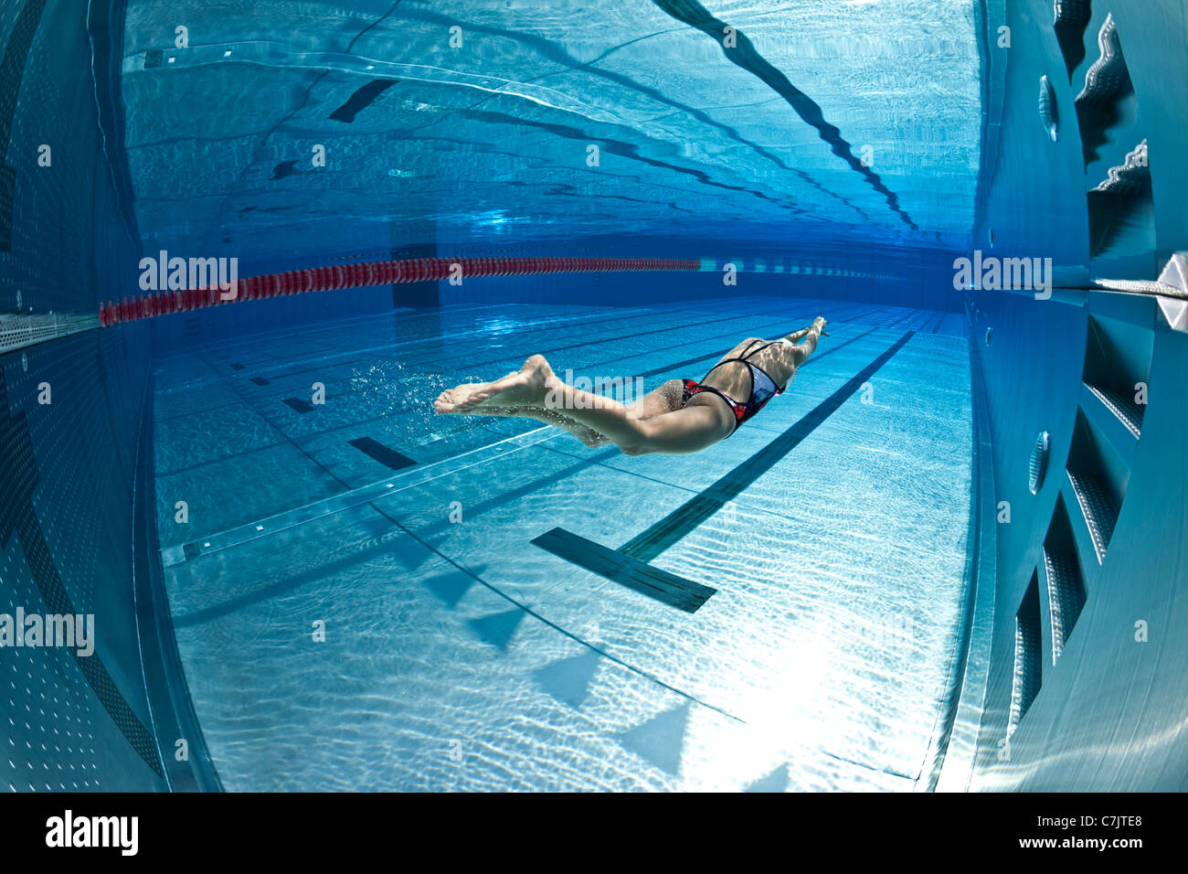 Olympic Swimming Pool Underwater a female swimmer training in an open air olympic pool (france Olympic Swimming Pool Underwater a female swimmer training in an open air olympic pool (france