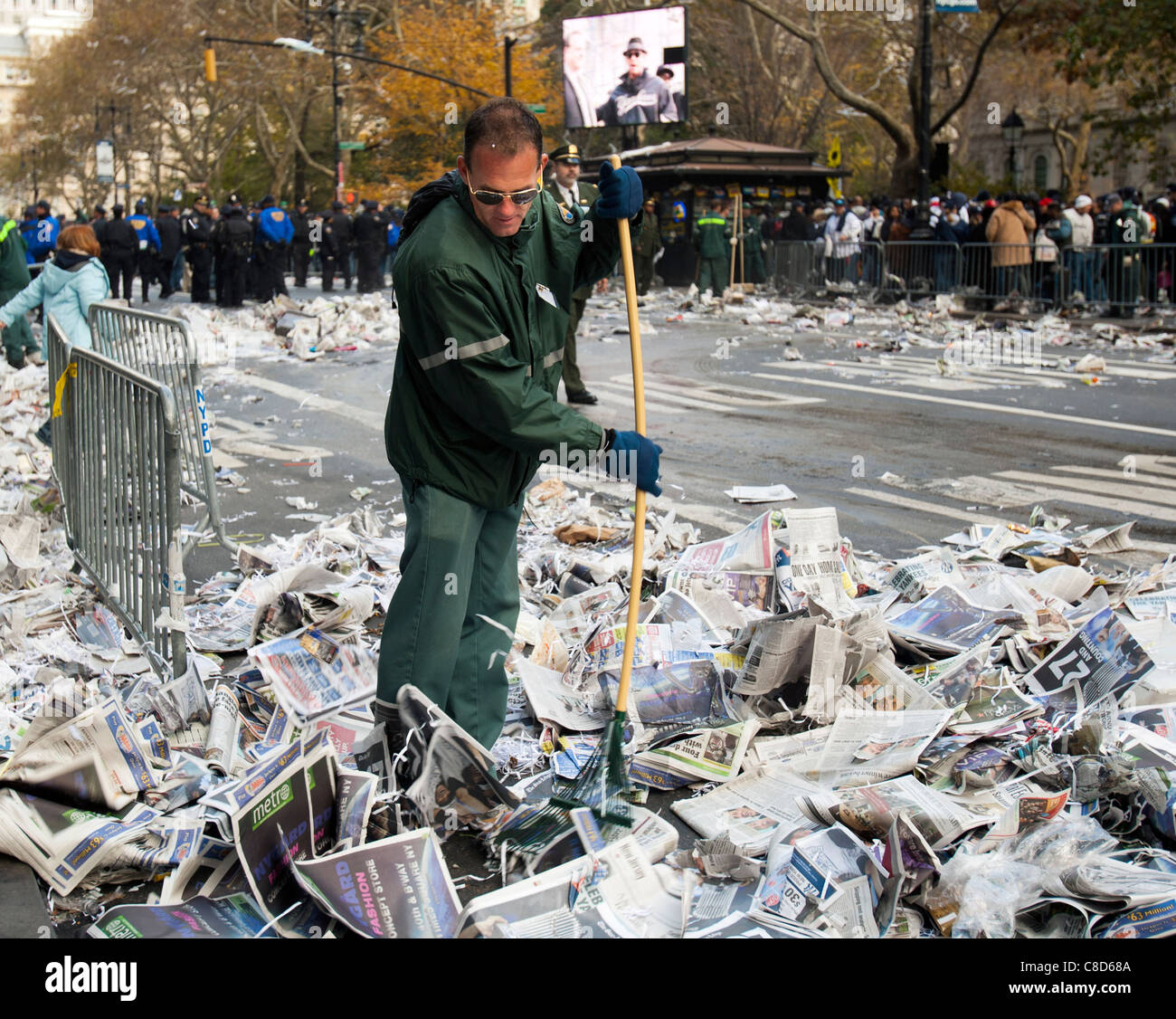 new-york-city-sanitation-worker-cleaning-up-after-a-parade-stock-photo