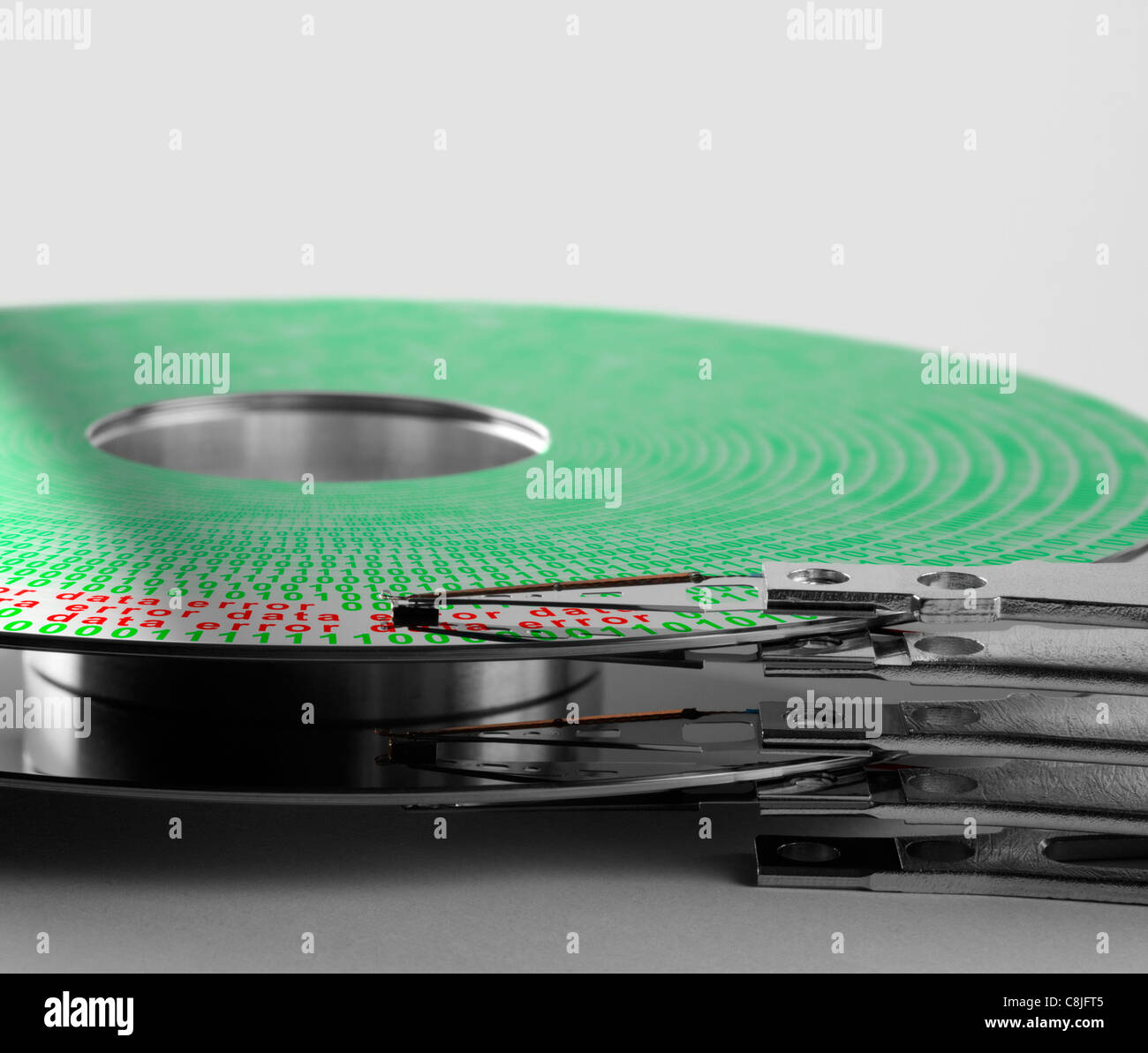 detail shot of a hard disk platter with actuator arm and symbolic