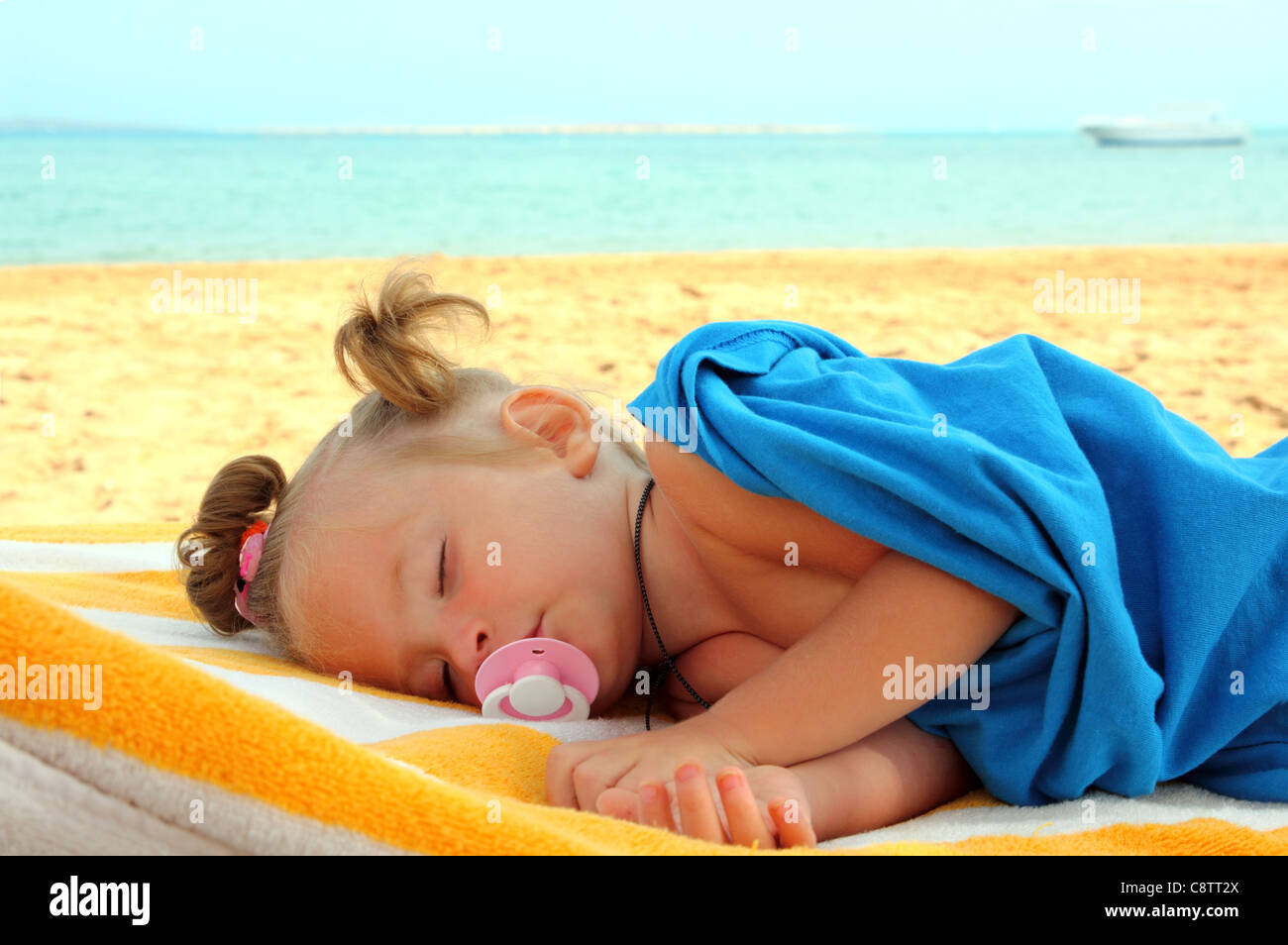 little girl sleeping on beach near sea Stock Photo ...