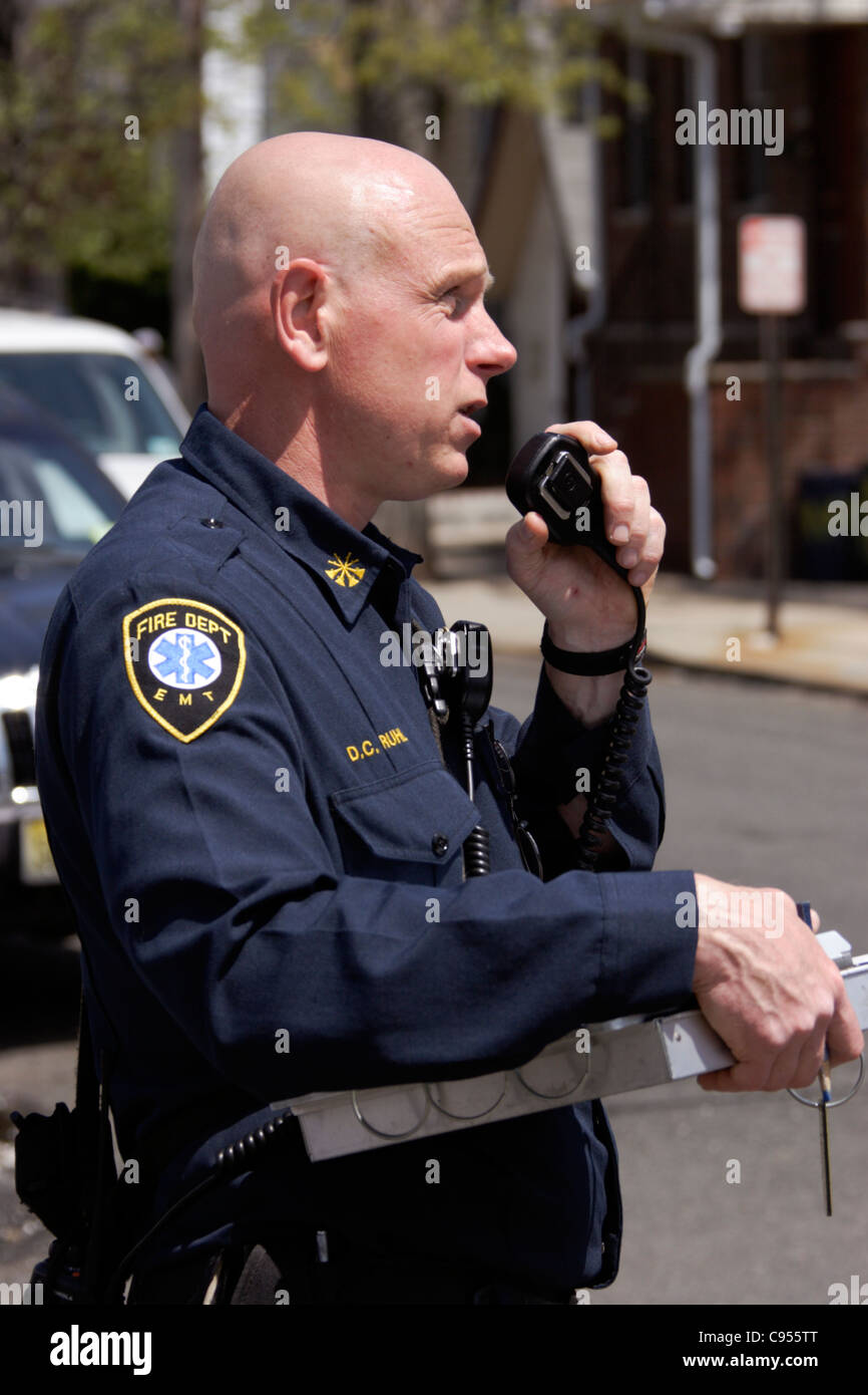 Fire Department EMT with a clipboard at the scene of an incident Stock