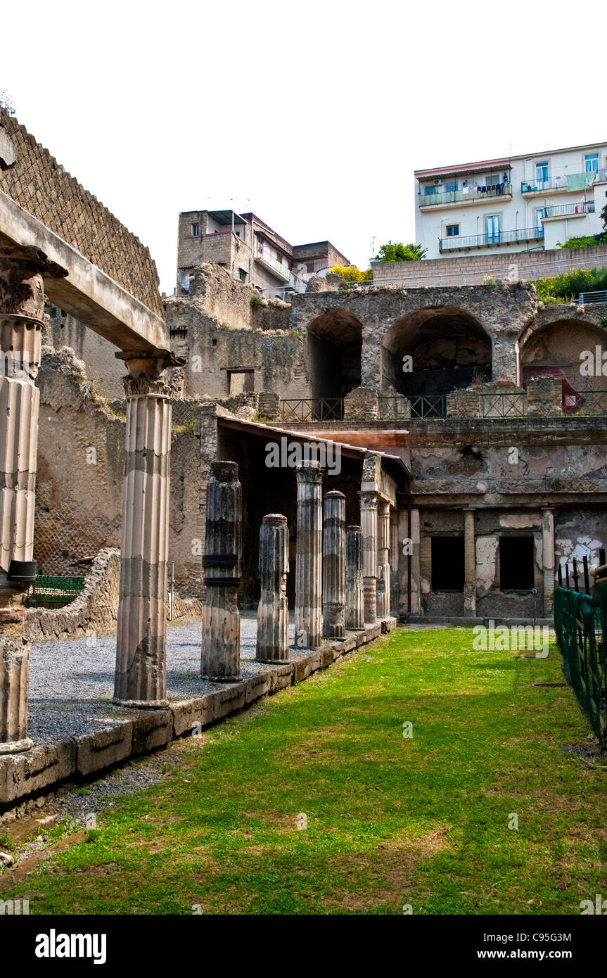 The modern houses of ercolano look down onto the fluted corinthian columns supporting the portico of