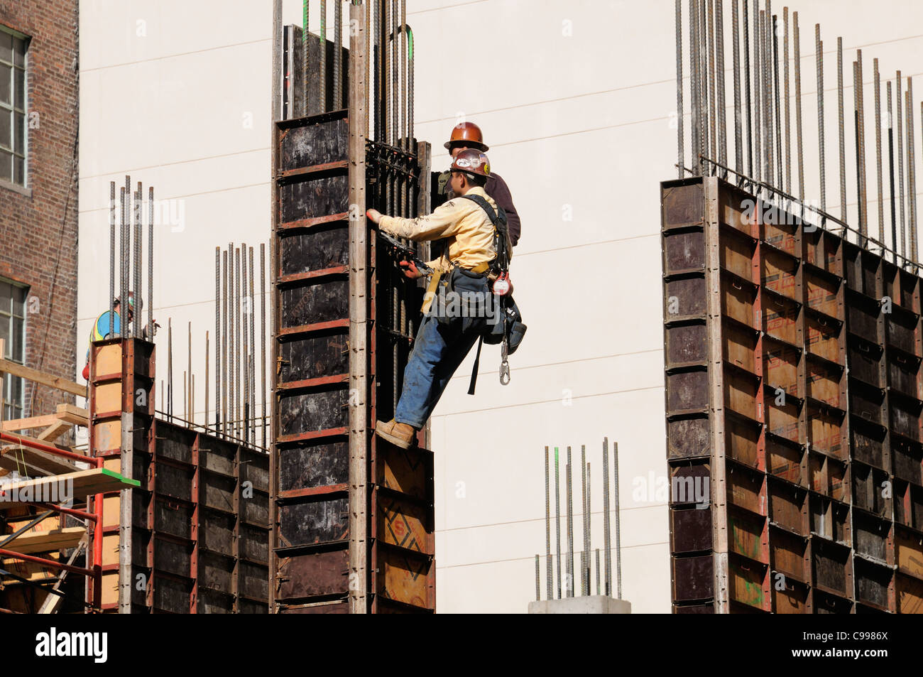 Construction workers wearing safety harness on a New York building