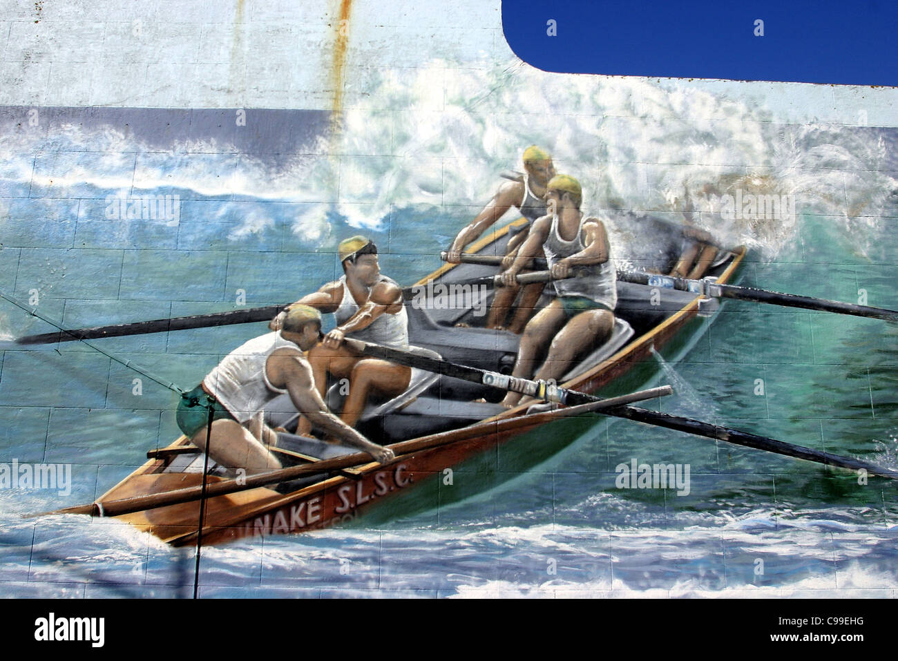 Surf life saving club boat painting on the side of a main street Stock