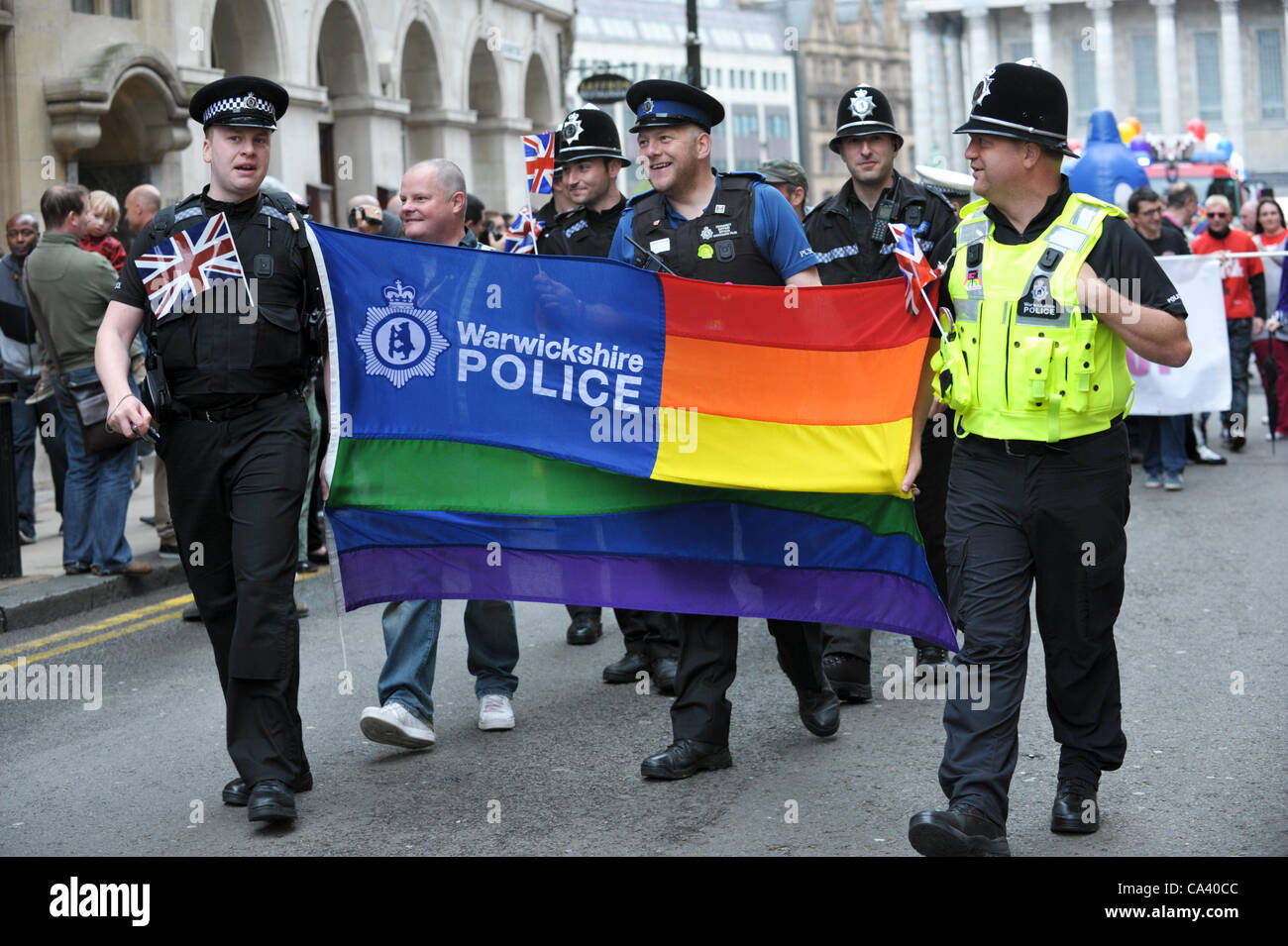 warwickshire-police-officers-with-a-gay-rainbow-flag-marching-to-celebrate-CA40CC.jpg