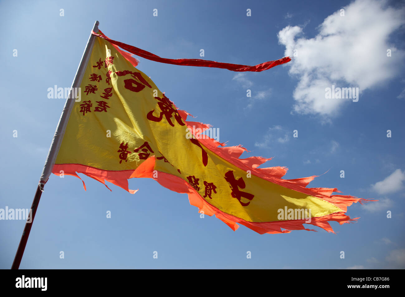 yellow triangular taoist flag flying outside shui sin temple stanley
