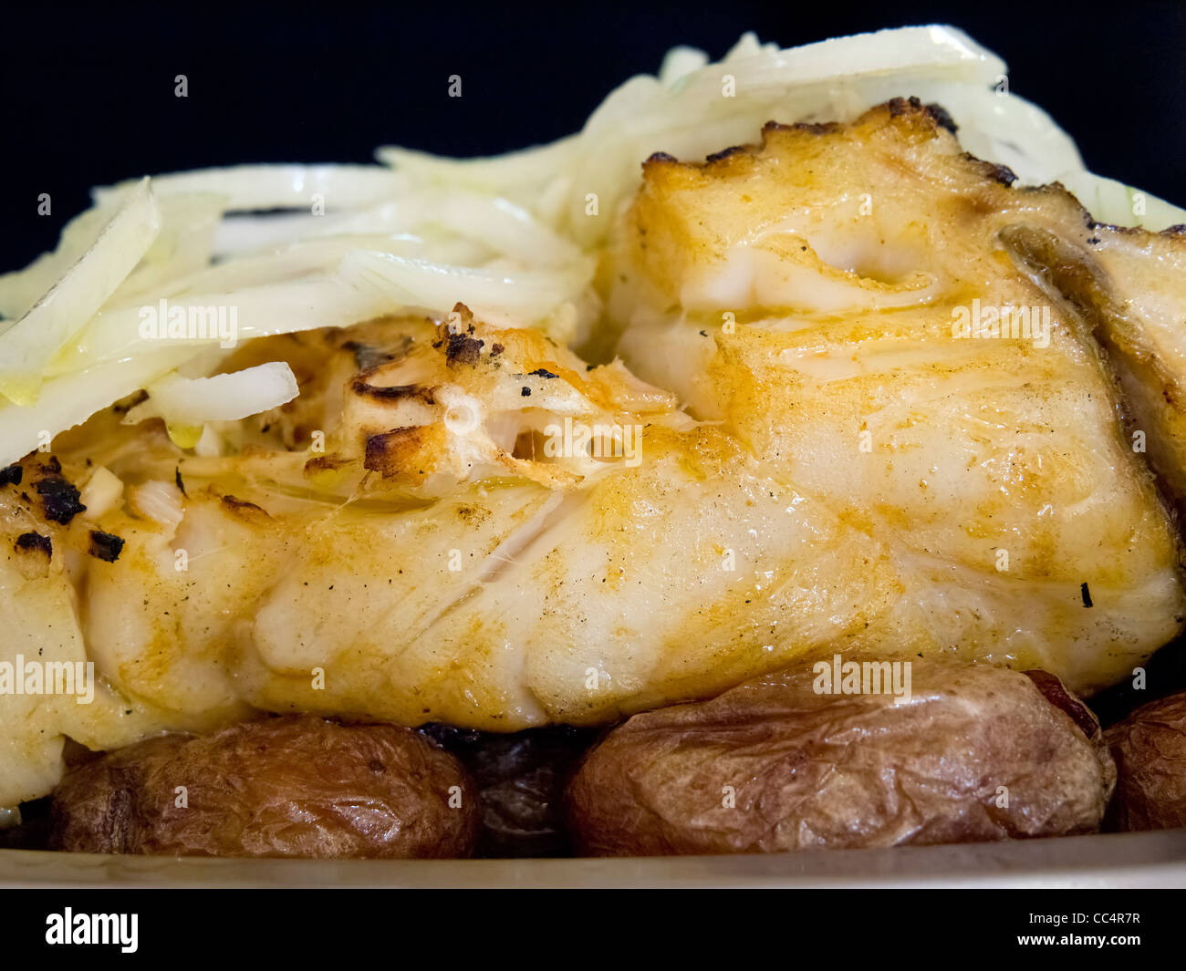 Typical portuguese dish Bacalhau a Lagareiro (cod fish with olive Stock