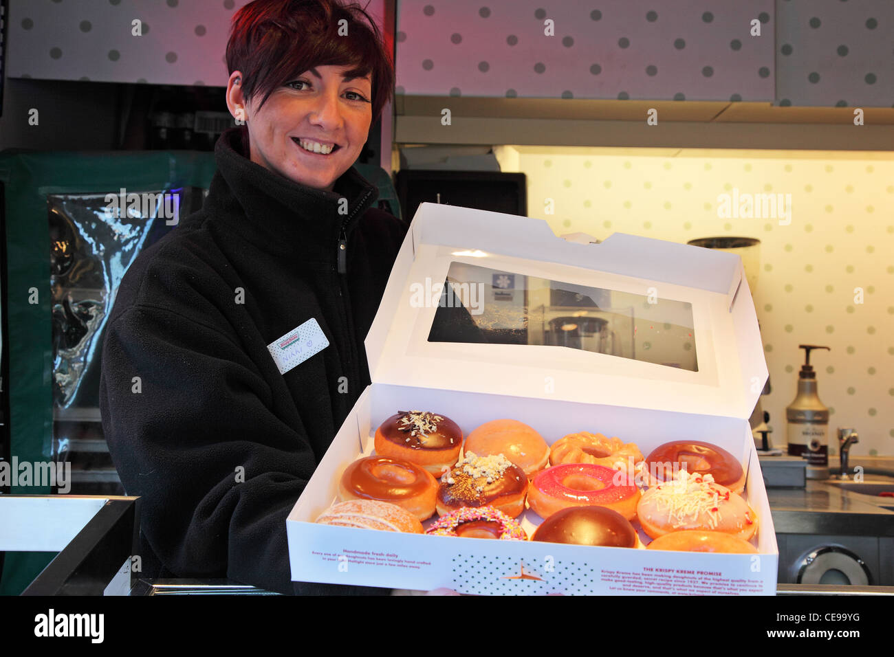 smiley girl selling doughnuts on the street Stock Photo
