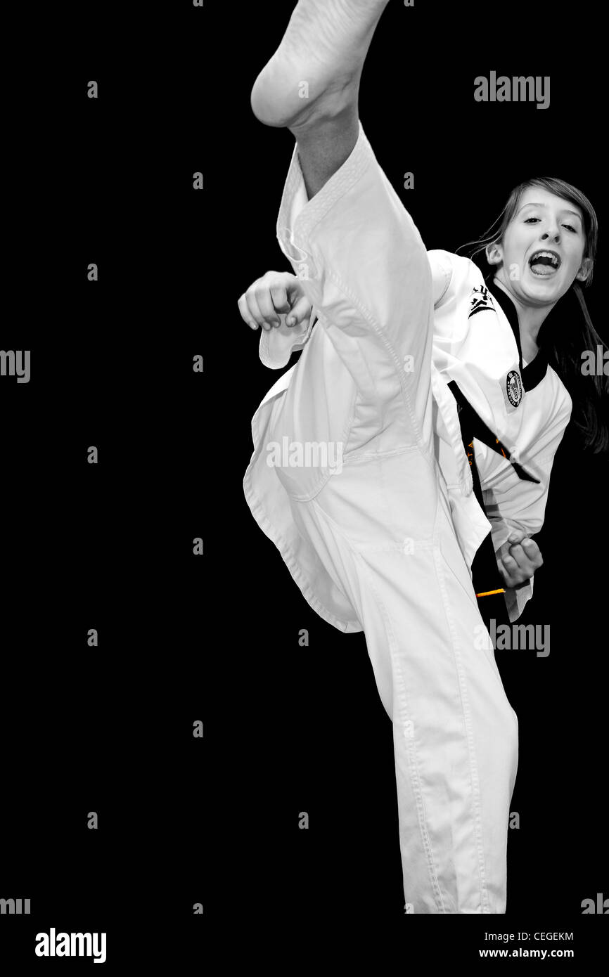a young girl does a high taekwondo turning kick Stock Photo 43388680
