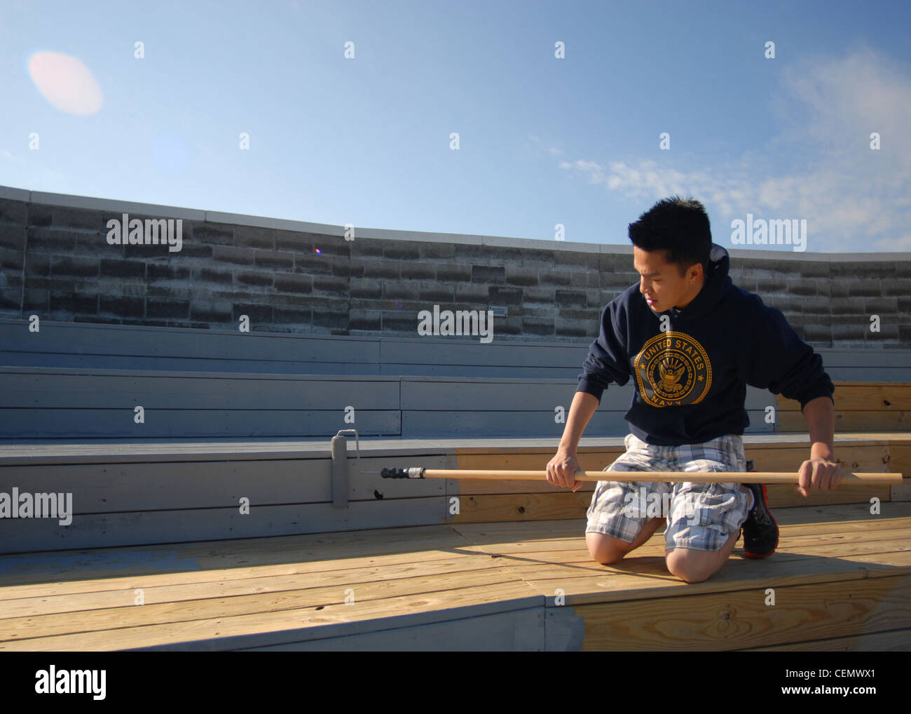 Aviation Boatswain's Mate (Handling) Seaman Bao Vu stains the deck of