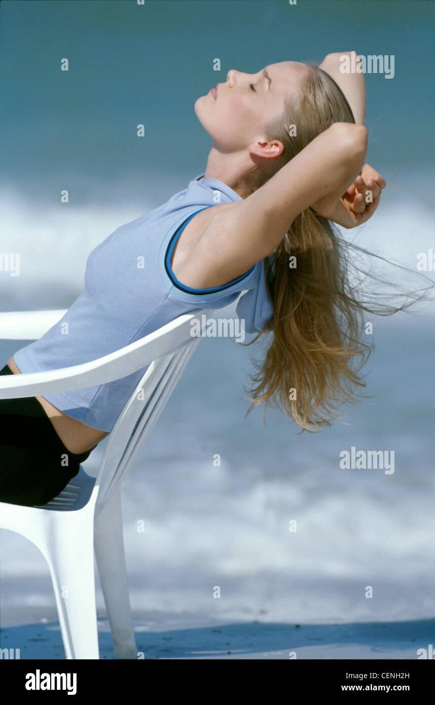 Female Long Blonde Hair Wearing Sleeveless Blue Top And Black Hotpants