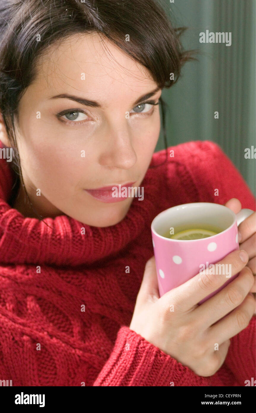 Cropped Image Of Brunette Female Hair Tied Back Wearing A Red Cable