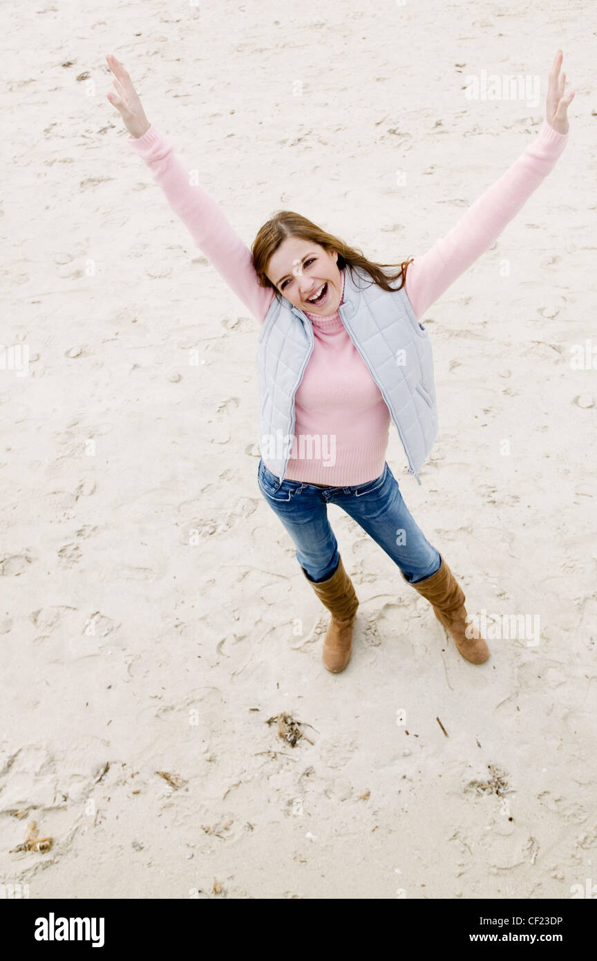 View From Above Of Female Long Blonde Hair Wearing Pink Poloneck Jumper And Blue Jeans Tucked