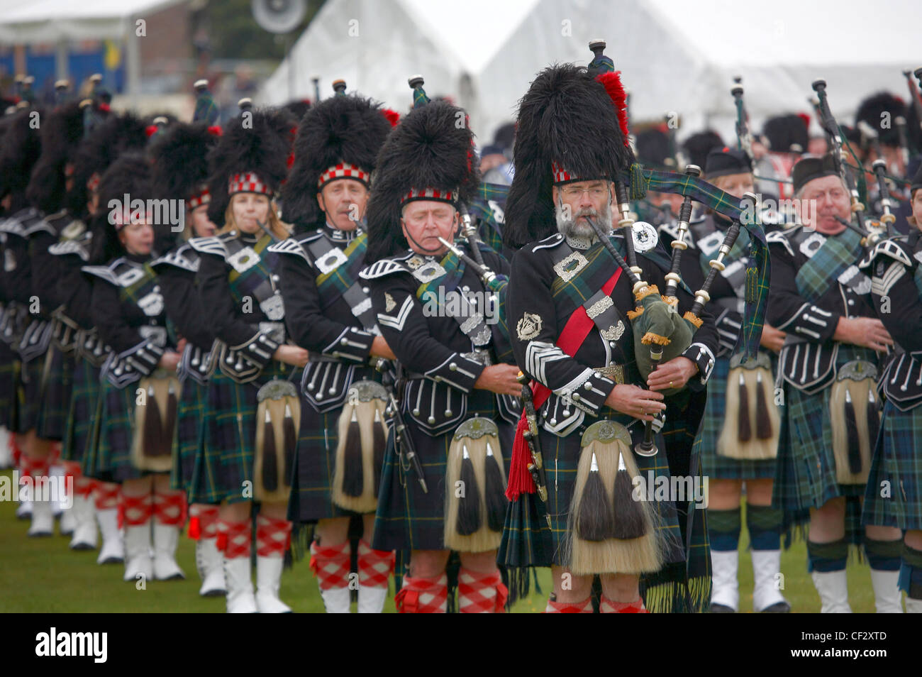 A pipe band performing at the Lonach Gathering and Highland Games Stock Photo, Royalty Free