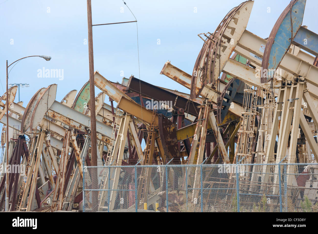 Long Beach California. Rows of rusty pumpjacks; pump jacks; nodding
