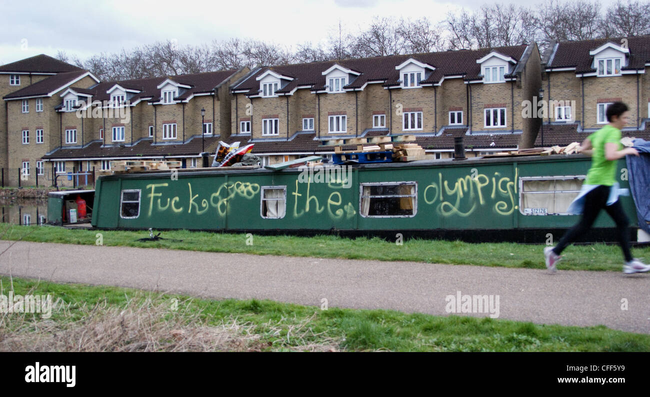 a-runner-passes-graffiti-on-narrowboat-o