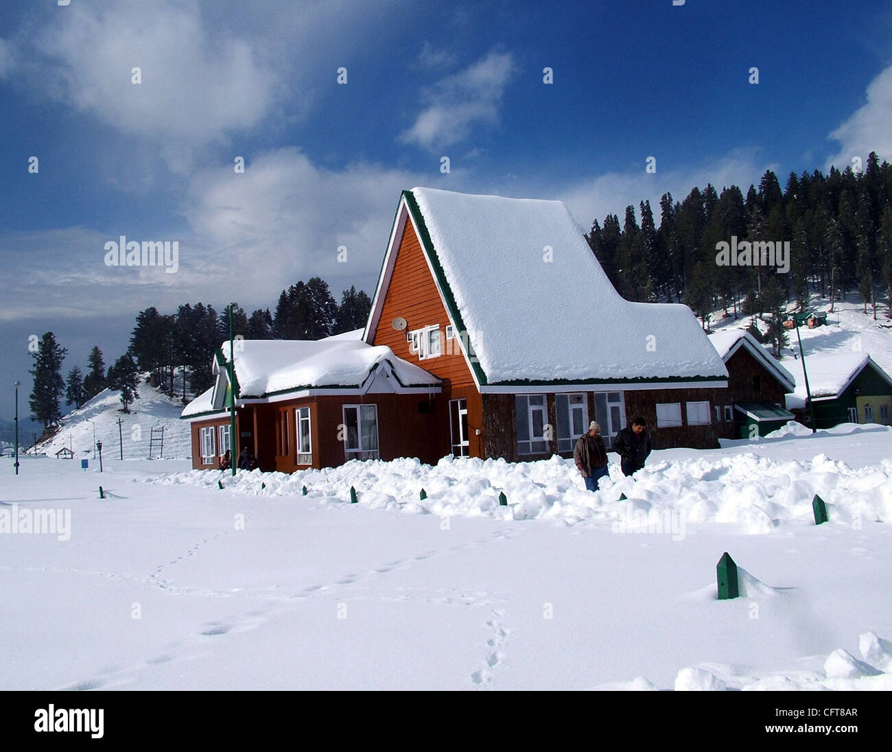 A beautiful view of snow covered trees and houses in gulmarg kashmir famous in whole world