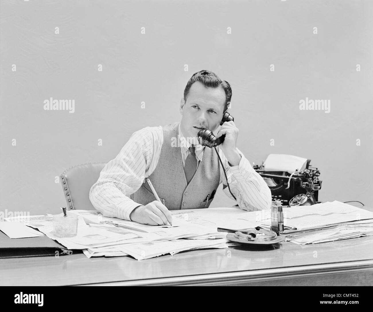 1930s-1940s-young-businessman-sitting-at