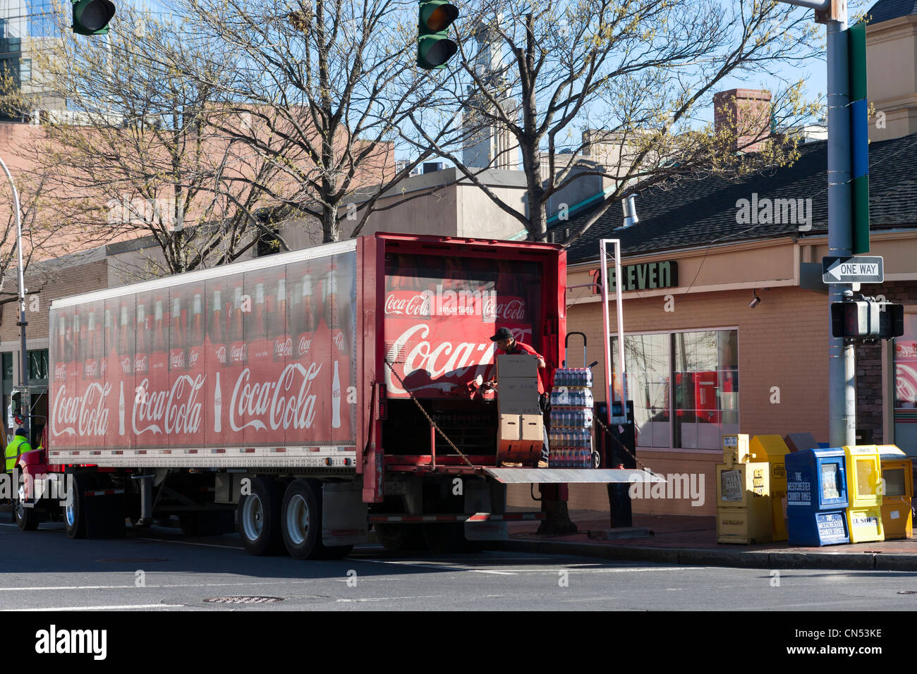 A rearloading truck makes a curbside Cocacola delivery at a Stock
