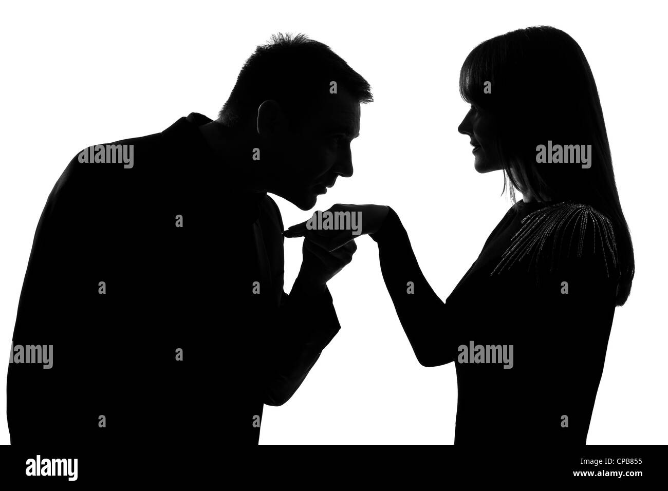 One Caucasian Man Kissing Hand Woman In Studio Silhouette Isolated