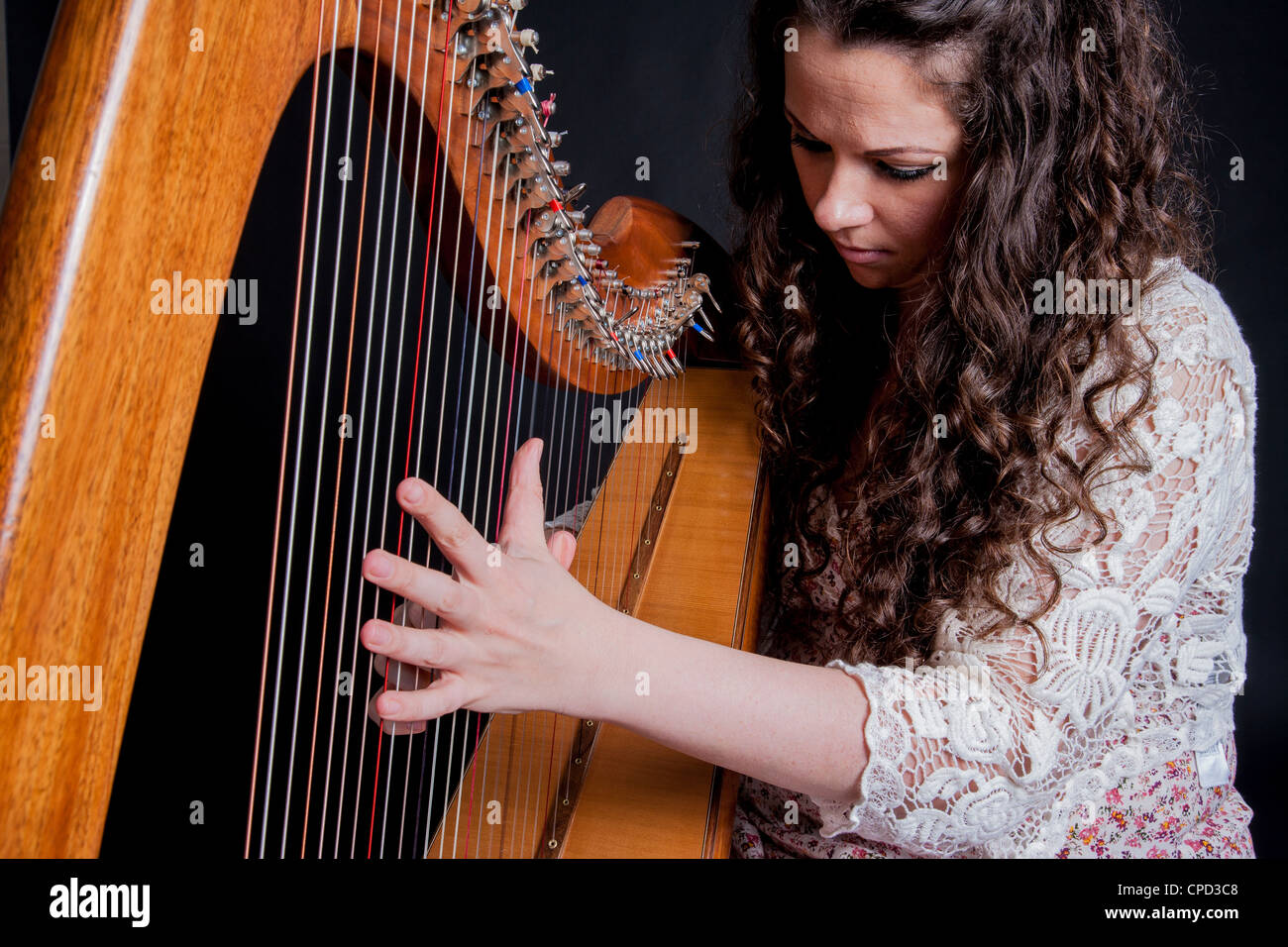 Irish woman playing a harp Stock Photo Alamy