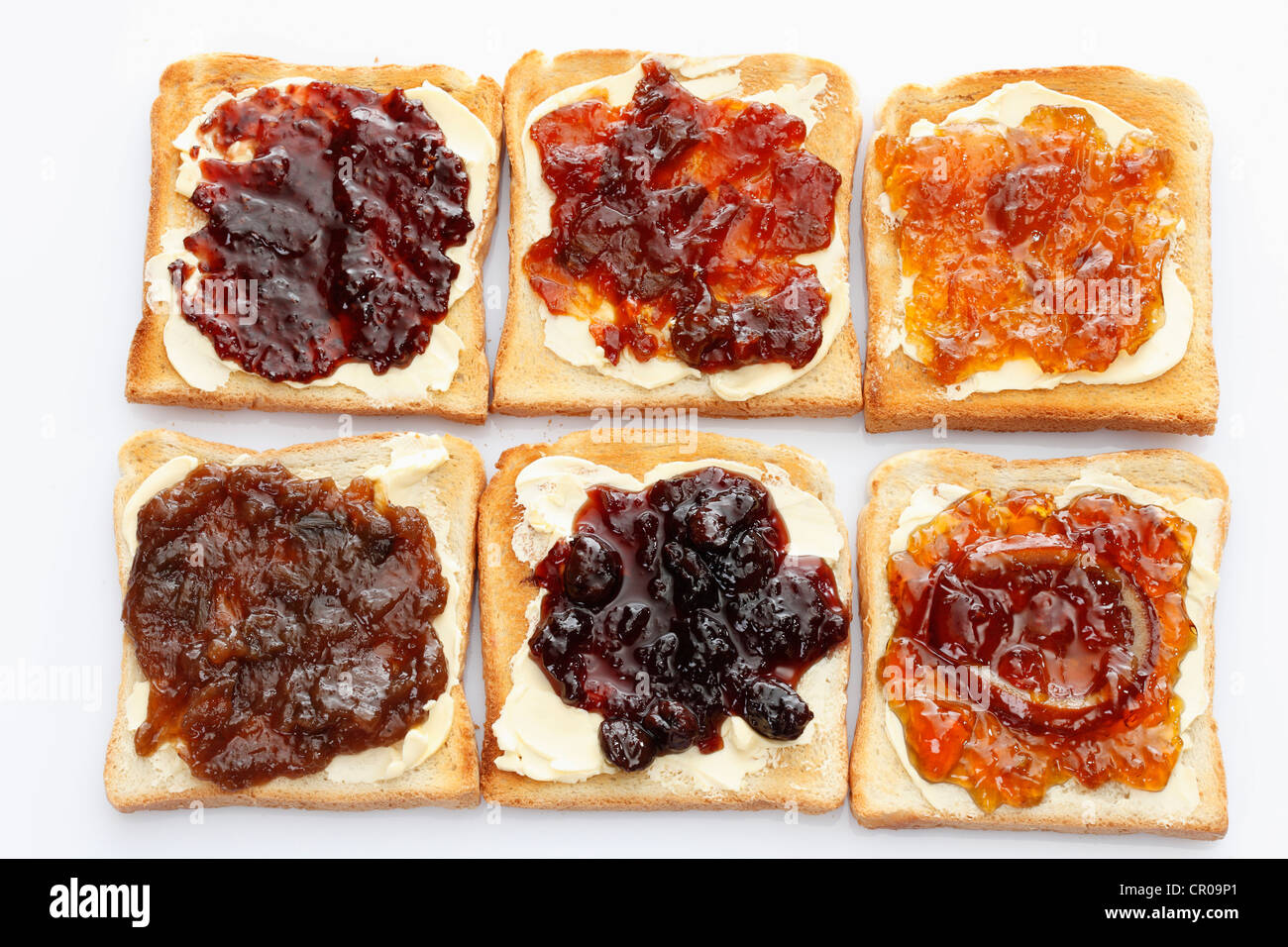 Six slices of toast with various jams, rhubarb jam, apricot jam Stock