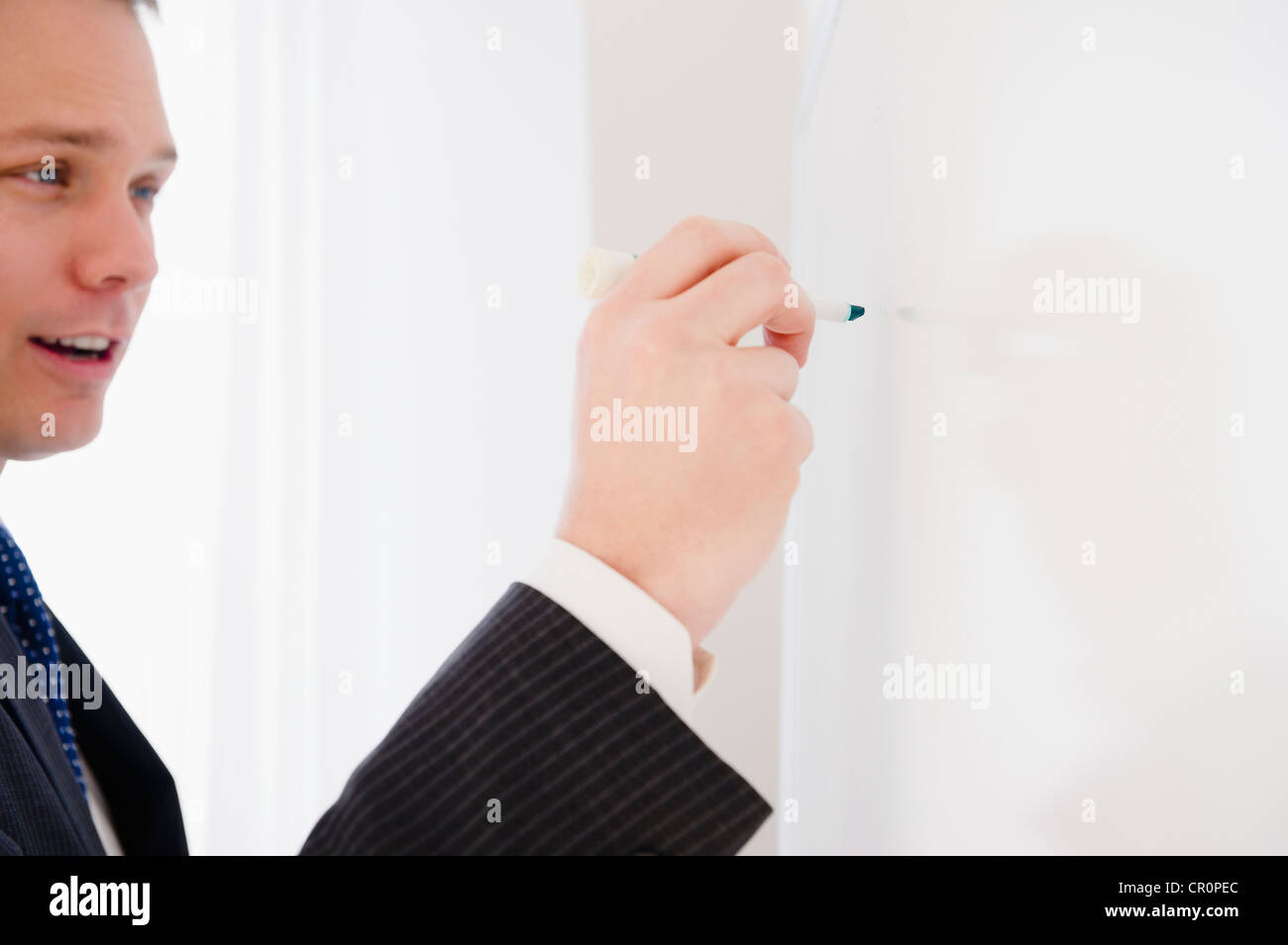 Caucasian Businessman Writing On Whiteboard Stock Photo Alamy