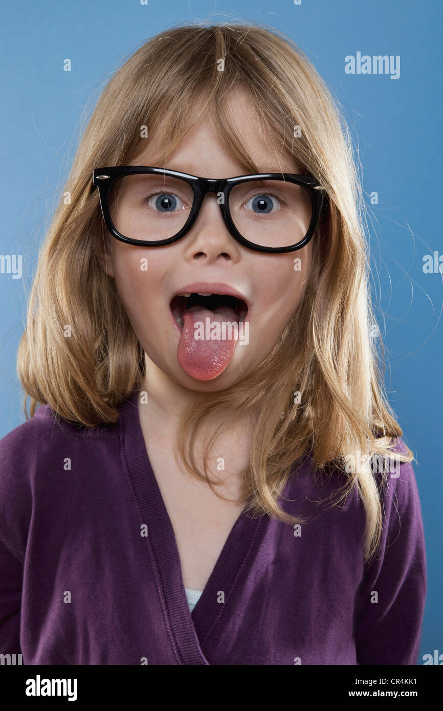 A young girl sticking out her tongue playfully, studio shot Stock Photo, Royalty Free Image