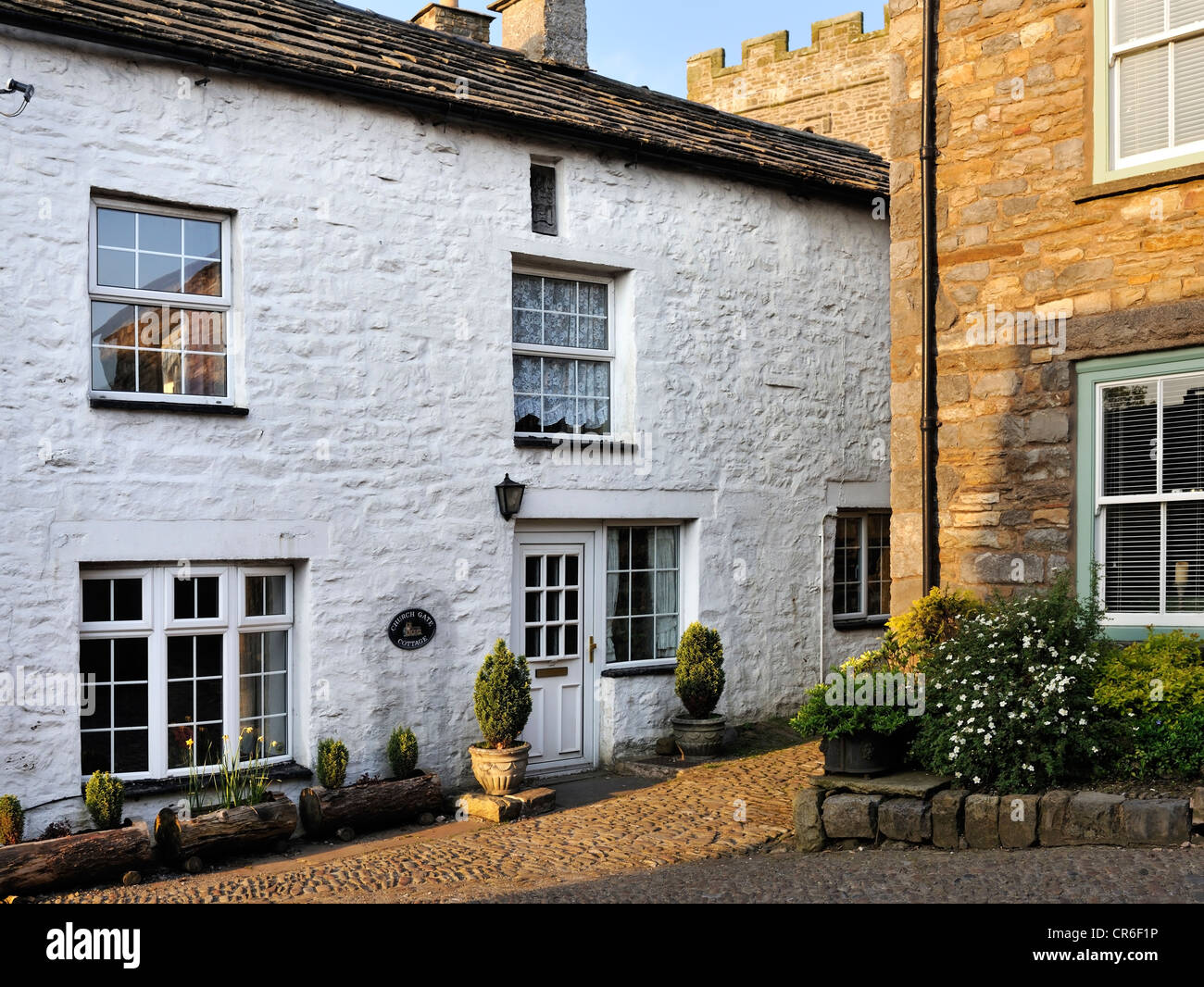 Whitewashed stone cottage in the picturesque village of Dent Stock