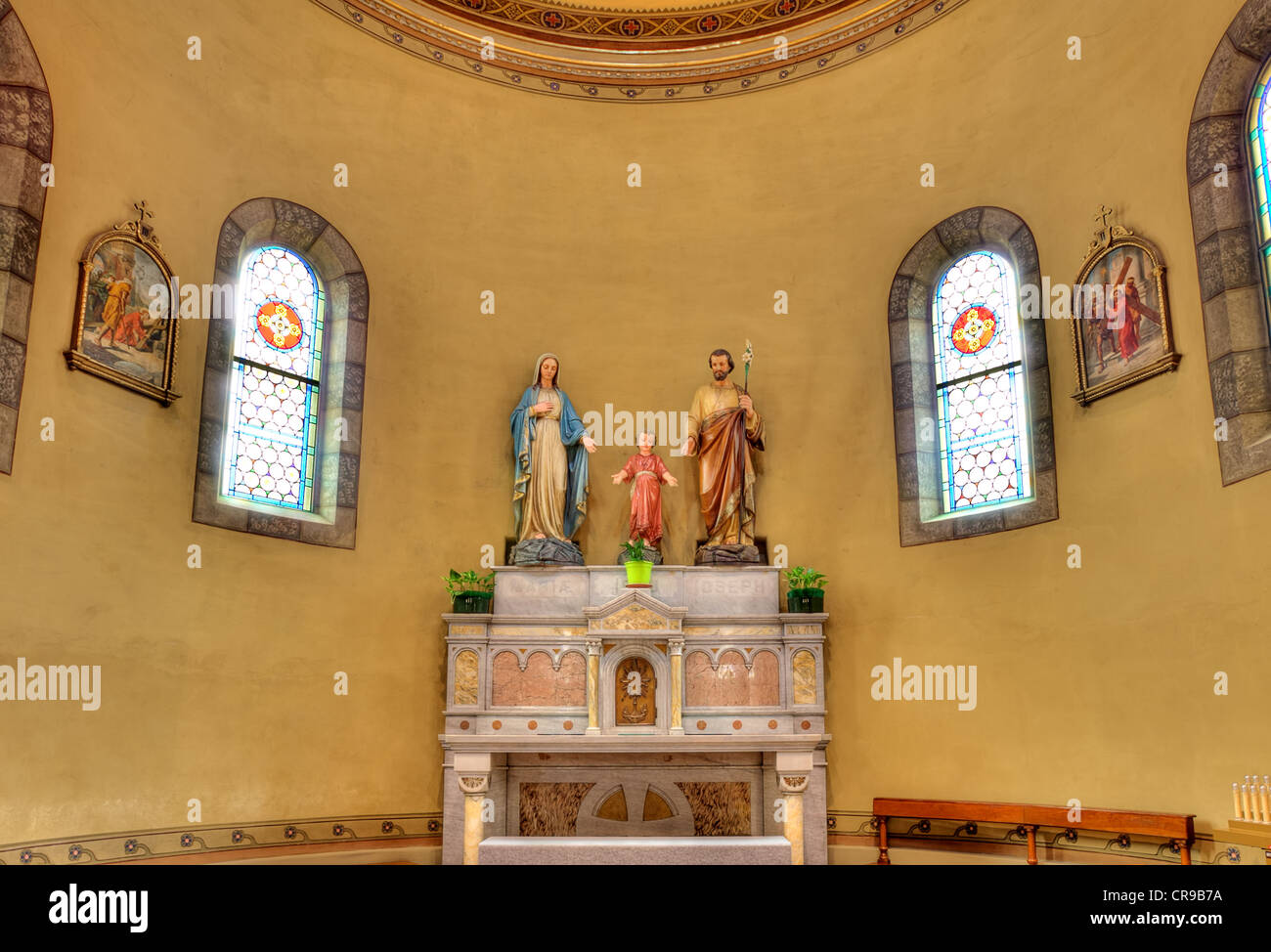 Statues of Mary, Jesus and Joseph on altar inside catholic church in Stock Photo, Royalty Free