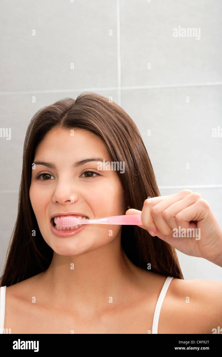 Woman Brushing Her Teeth In Mirror Stock Photo Alamy