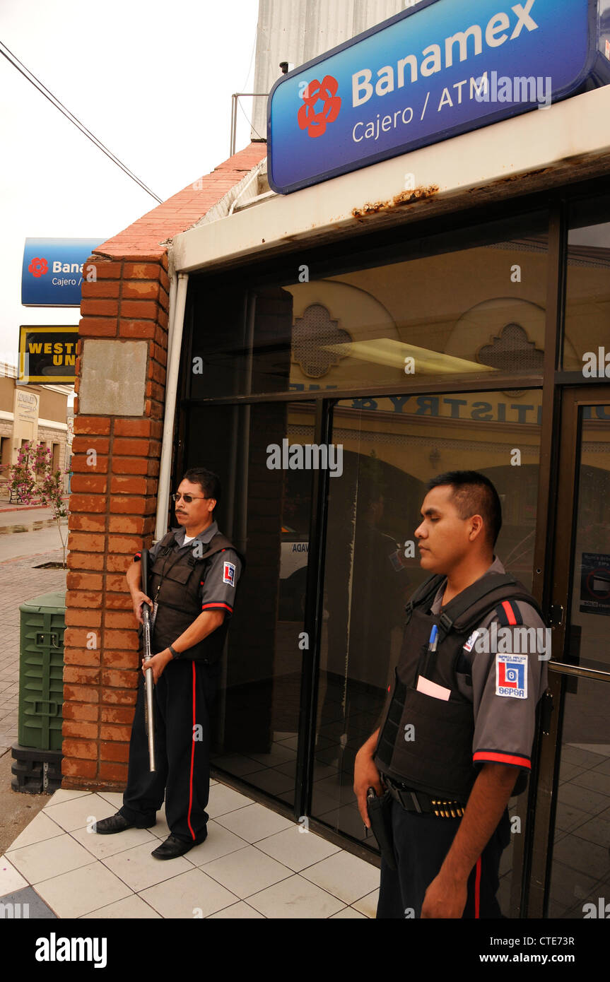Security guards guard a bank along Calle Obregon in Nogales, Sonora