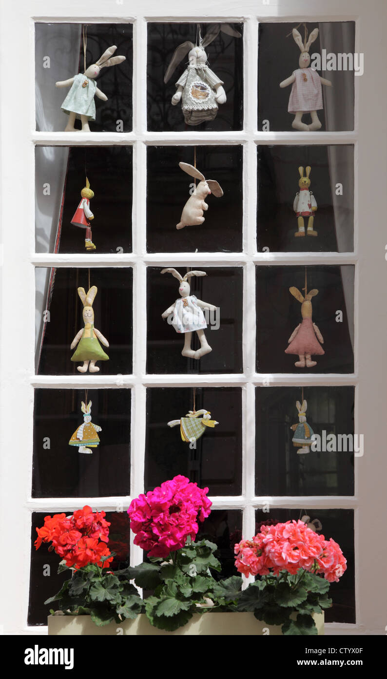 small-paned-window-with-rabbit-dolls-at-