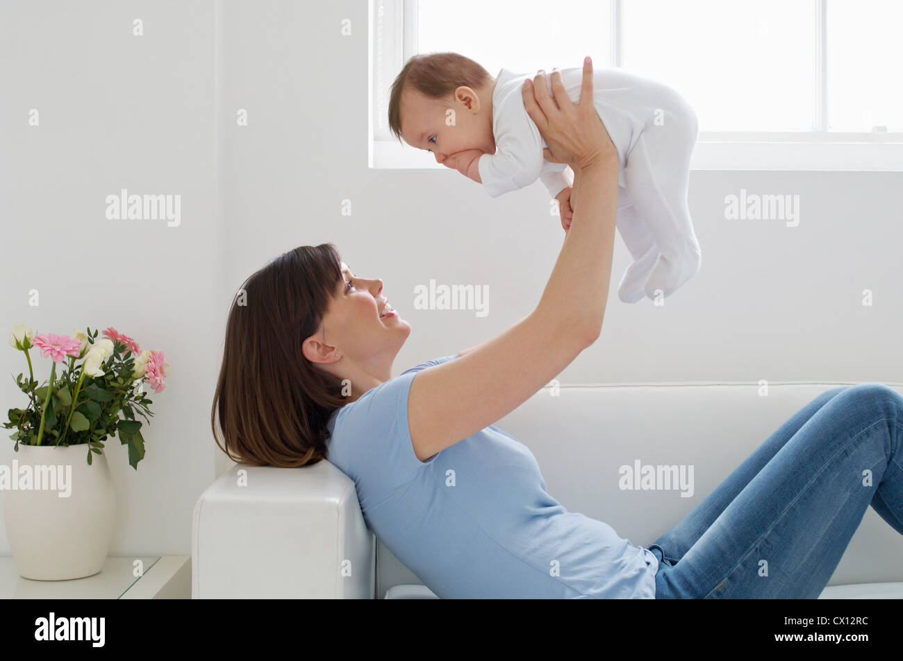 Mother lifting up baby girl Stock Photo, Royalty Free Image 50425968