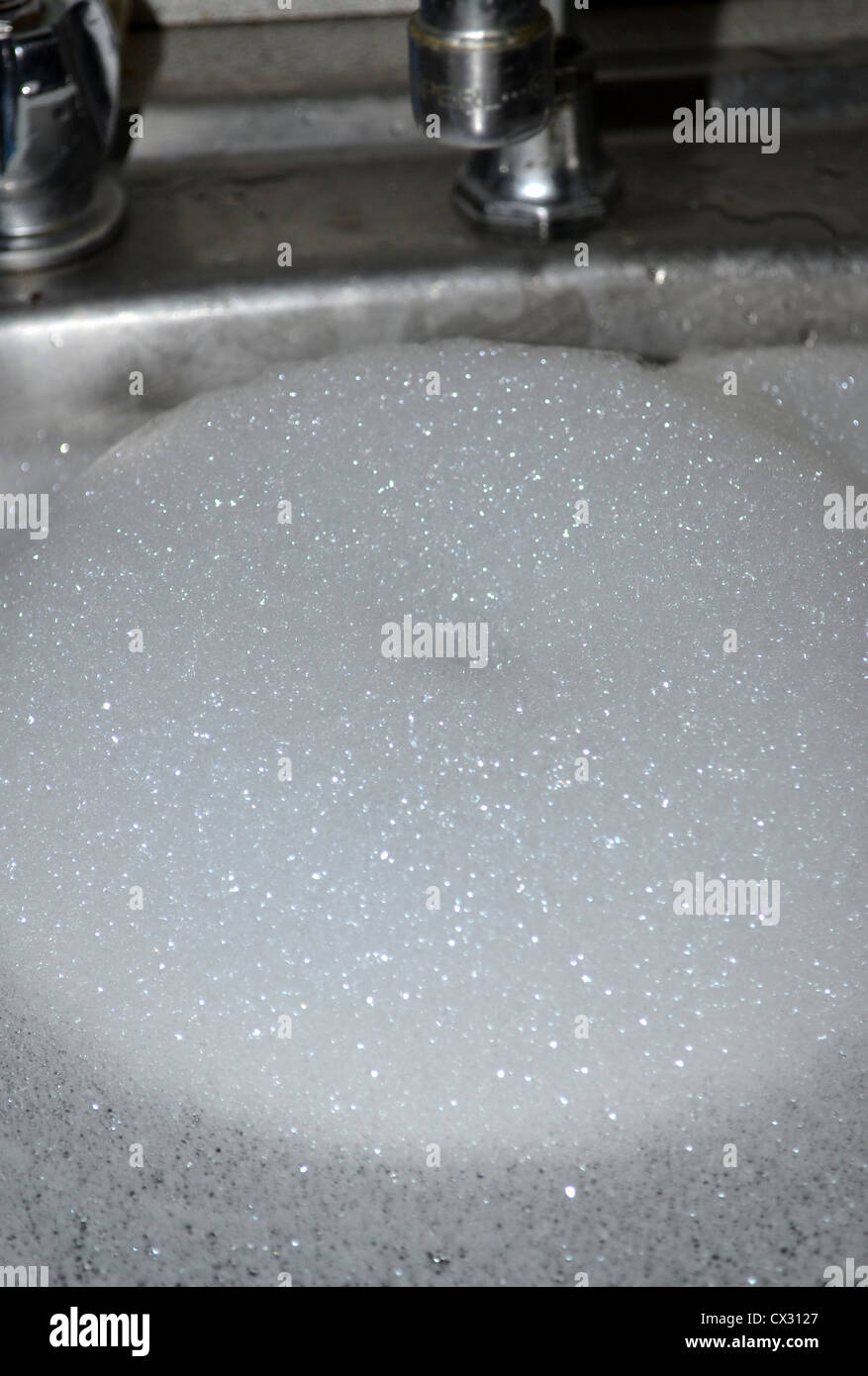 kitchen sink full of soapy water soapsuds / foam tap faucet Stock Photo, Royalty Free Image