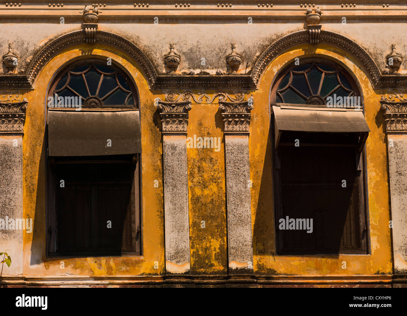 Stock photo two windows of an old house with decrepit wall pondicherry india