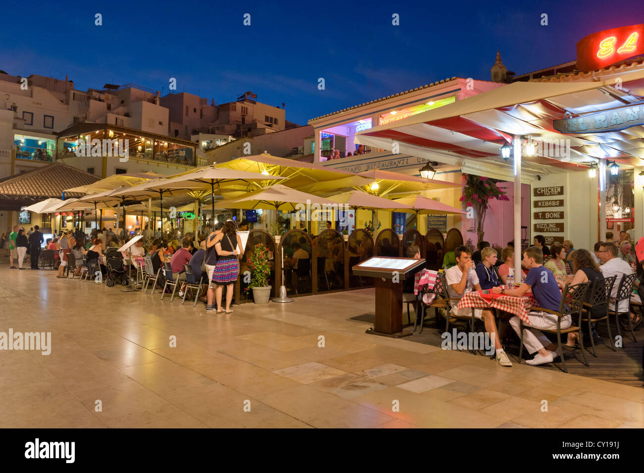 Portugal, the Algarve, Albufeira, sea front restaurants at dusk Stock
