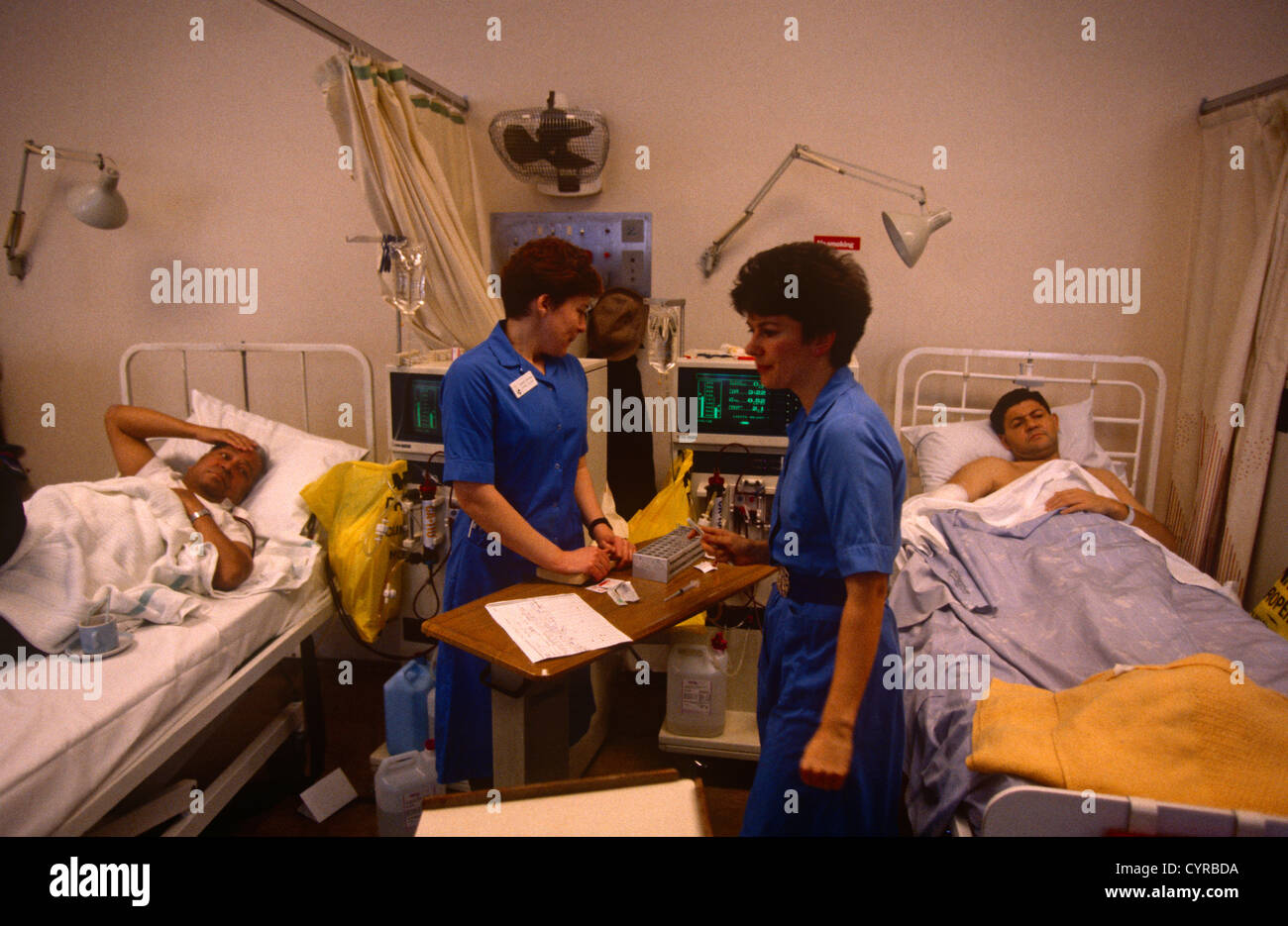 Nurses dispense medicine in the mens' surgical ward at St Stock Photo