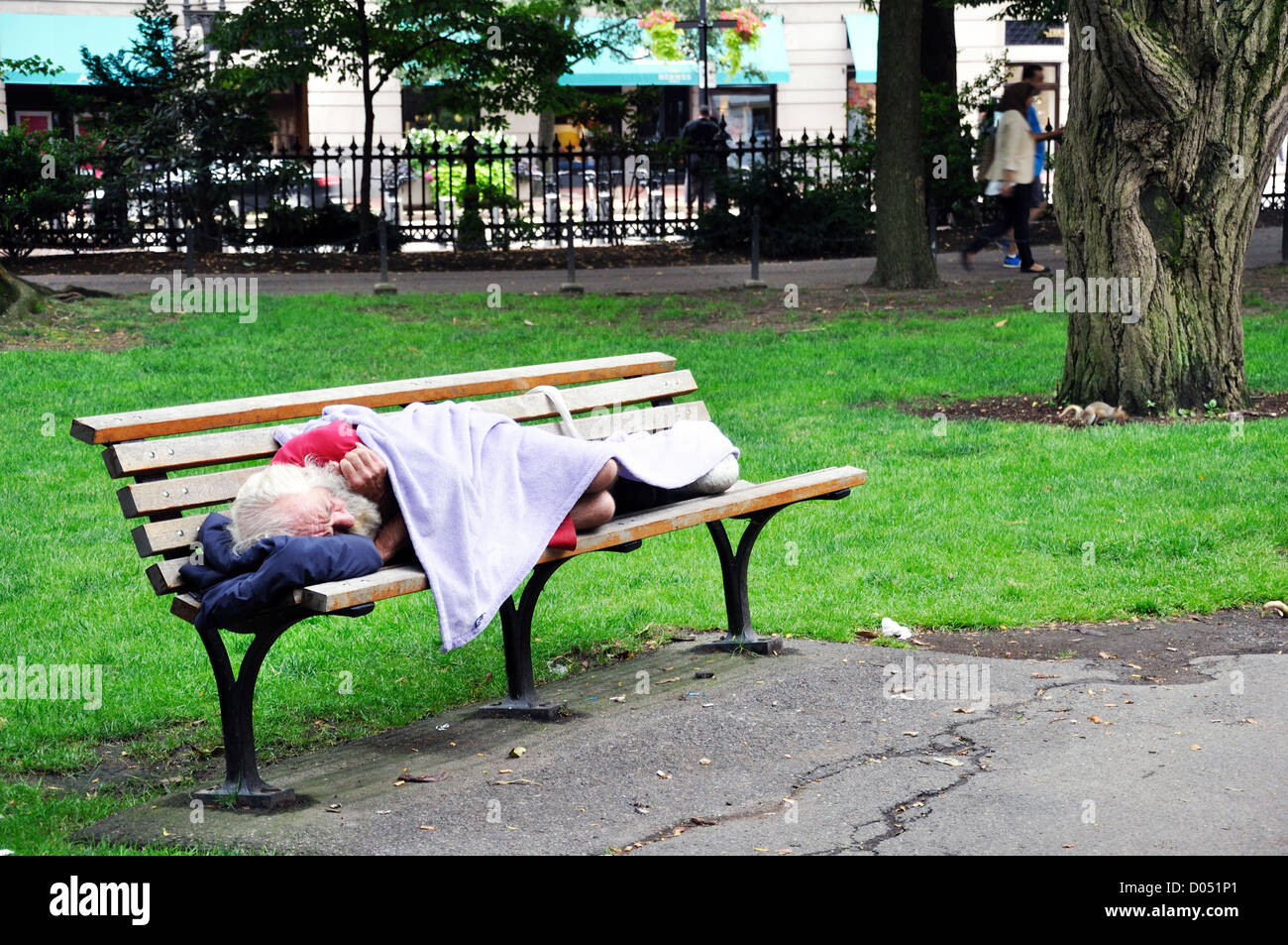Homeless Man Sleeping In Park Boston Massachusetts USA Stock Photo