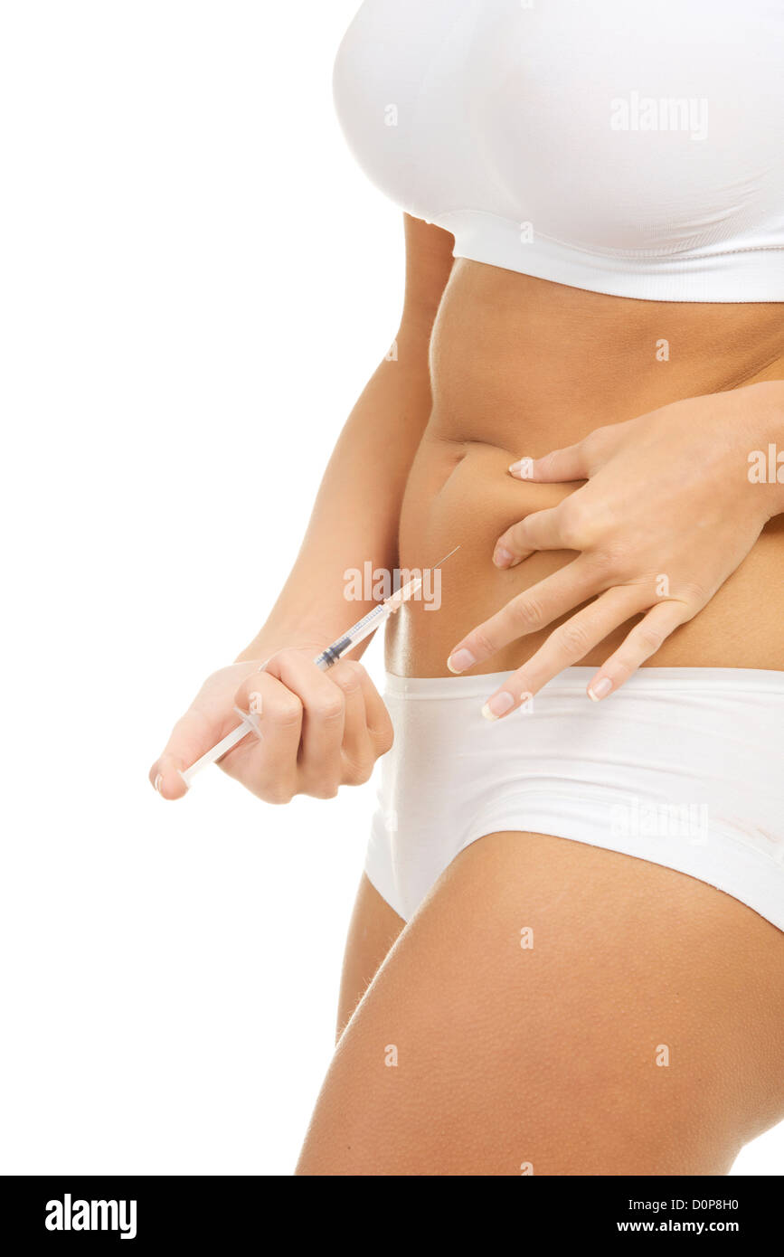Close up of woman doing insulin injection in her belly, isolated on