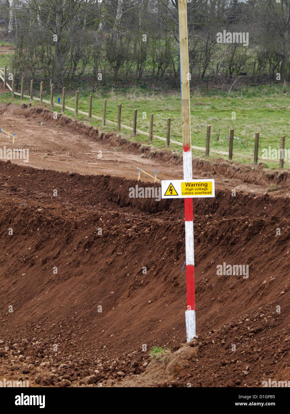 goalpost and warning sign of overhead power line lines cable cables