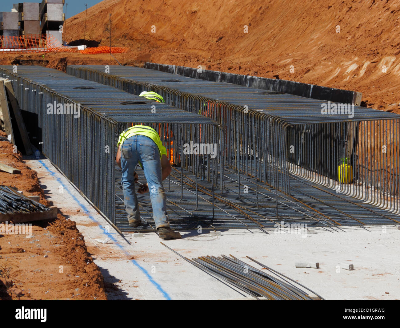 Steel fixer tying reinforcement bars in a bridge foundation base Stock