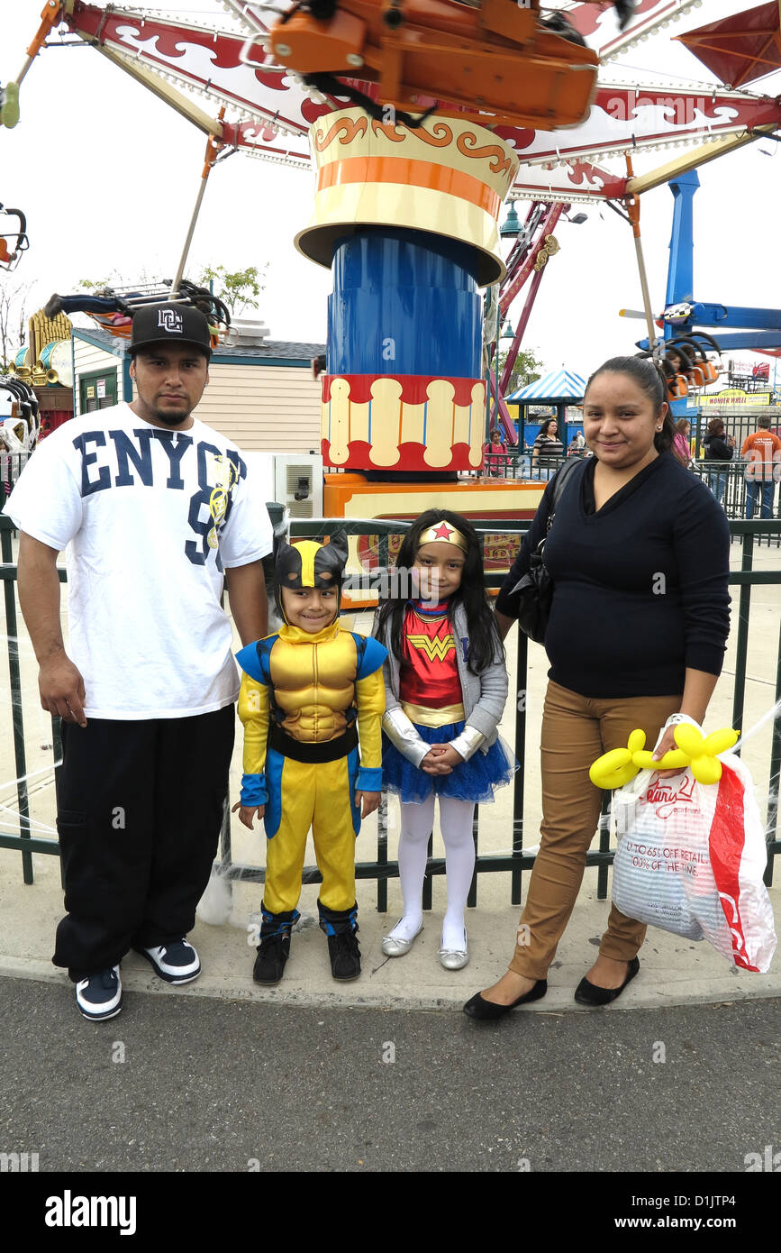 hispanic family poses for a photo at luna park after the coney island halloween childrens parade in brooklyn 2012 - Halloween At Coney Island hispanic family poses for a photo at luna park after the coney island halloween childrens parade in brooklyn 2012 - Halloween At Coney Island