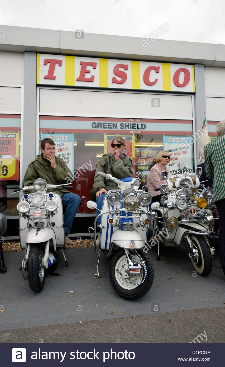 mods on Lambretta and Vespa scooters in front of 1960's TESCO Stock