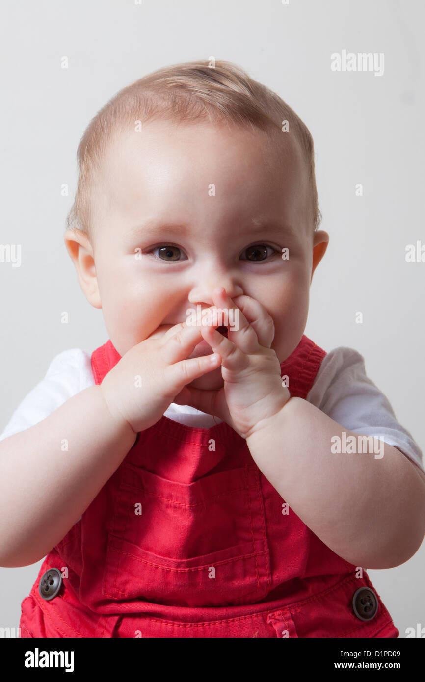 Baby Girl With Hands In Mouth Stock Photo Alamy