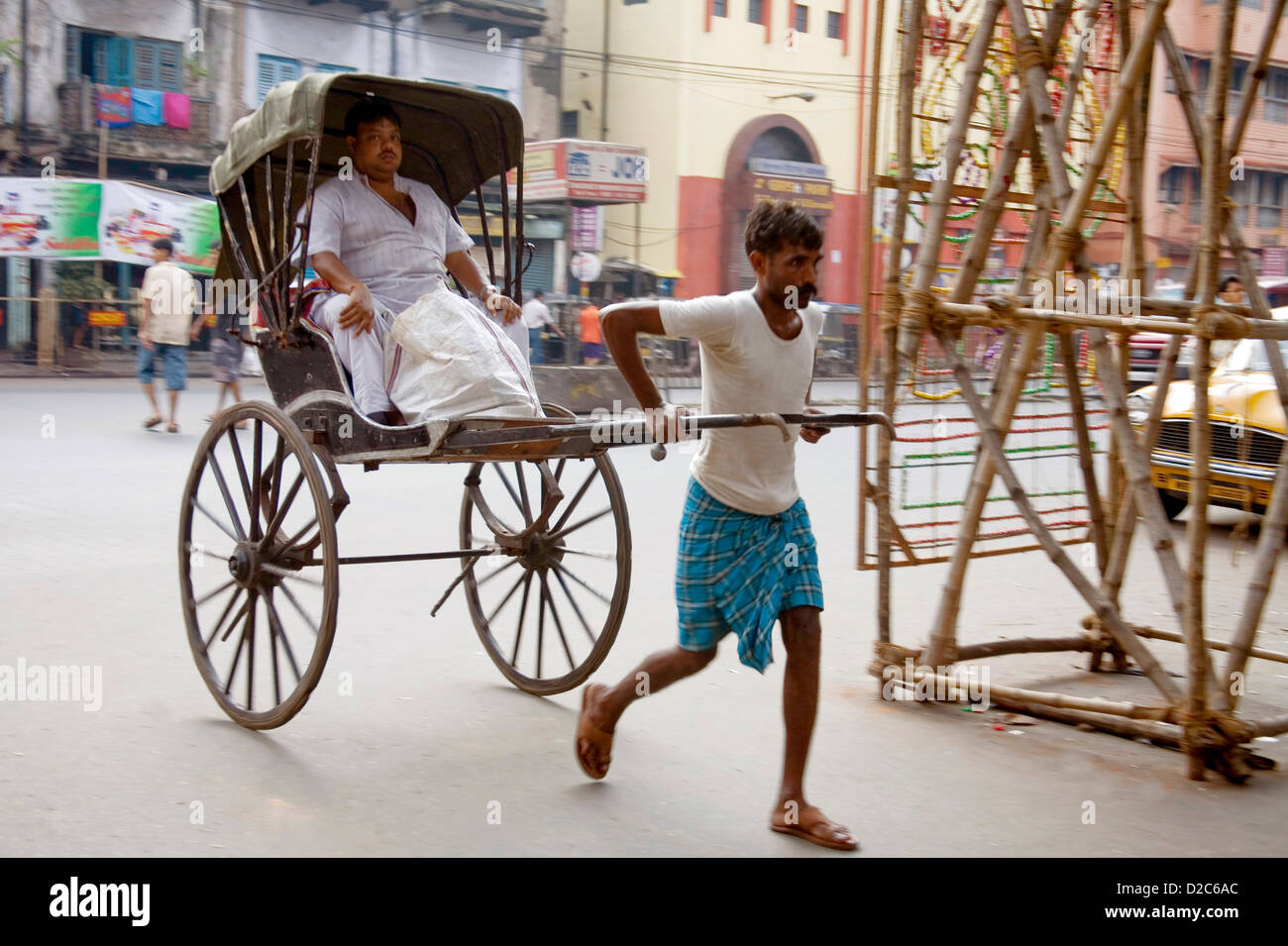 man-pulling-hand-rickshaw-with-passenger